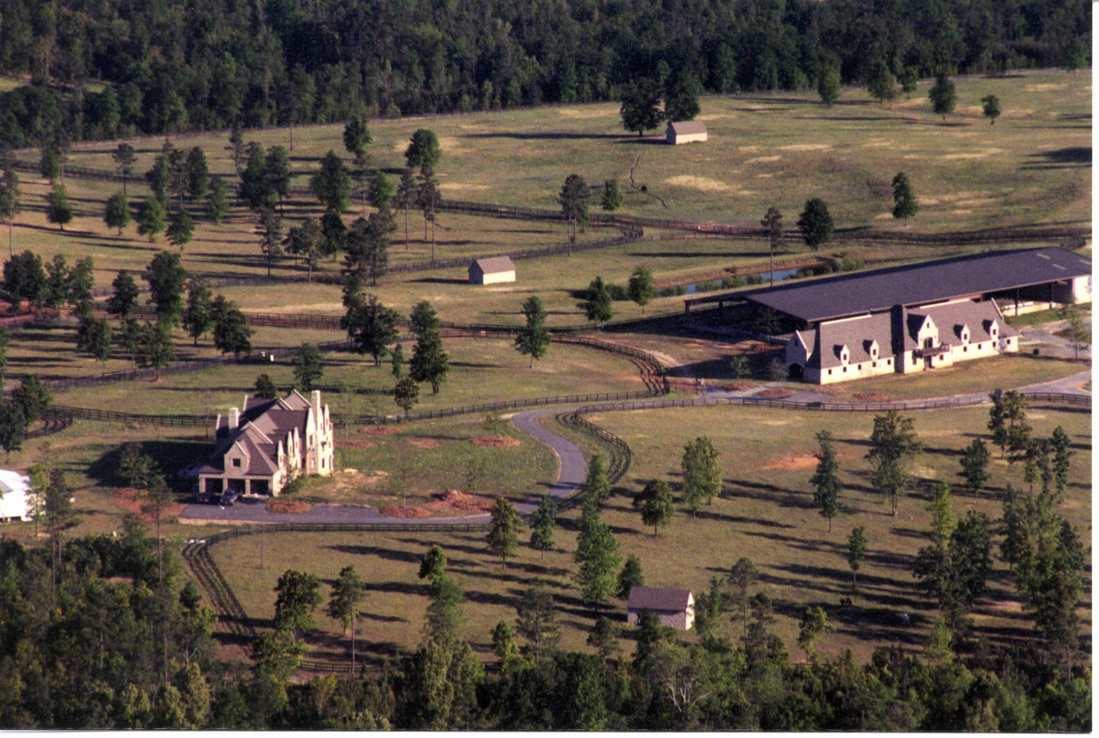 Aerial view of barn, arena, house, paddocks
